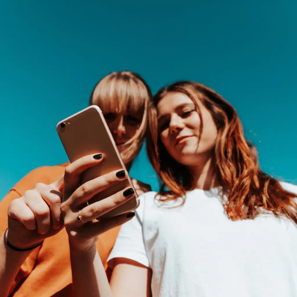 2 girls viewing social media on their phone